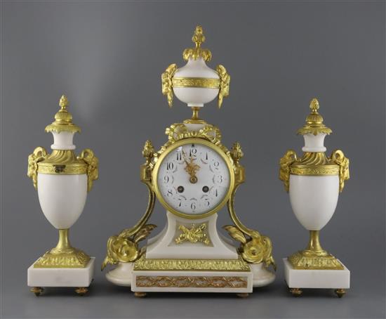 A Louis XVI style ormolu mounted white marble clock garniture, clock height 15.75in. urns height 11.75in.